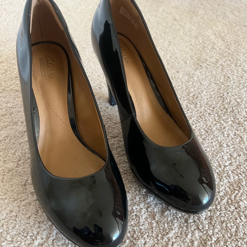 Black patent high heel pumps.